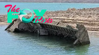 A World War II-era Higgins boat rests on its side near the shore of the dwindling Lake Mead waters in California.