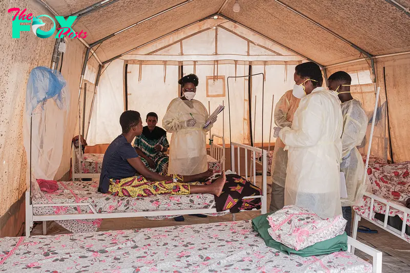 Health workers speak with patients inside a ward for women infected with Mpox at the Kamenge University Hospital's Mpox treatment center in Bujumbura, Burundi, on Aug. 22, 2024.