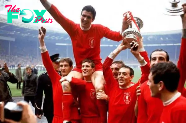 Liverpool captain Ron Yeats (top) holds onto the FA Cup as he is hoisted aloft by his jubilant teammates after their 2-1 win: (l-r) Geoff Strong, Yeats, Wilf Stevenson, Peter Thompson, Ian St John, Gerry Byrne, Ian Callaghan - PA Photos/PA Archive/PA Images