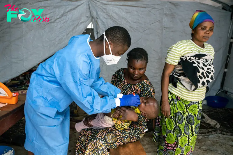 A laboratory specialist takes a sample from a patient suspected of being infected with mpox at the Kavumu hospital in Kabare territory, South Kivu region, Democratic Republic of Congo, on Sept. 3, 2024.