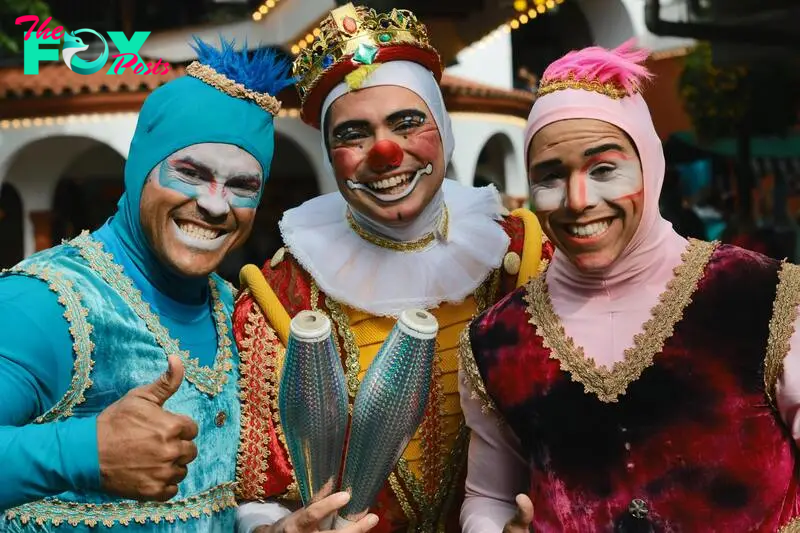 Outrageously-dressed people posing outside a house | Source: Pexels