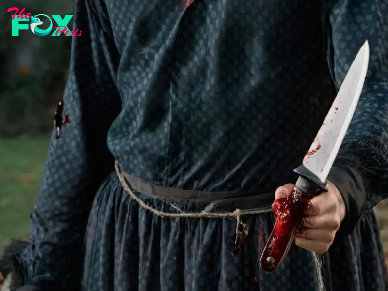 A hand holding a "bloody" knife | Source: Midjourney