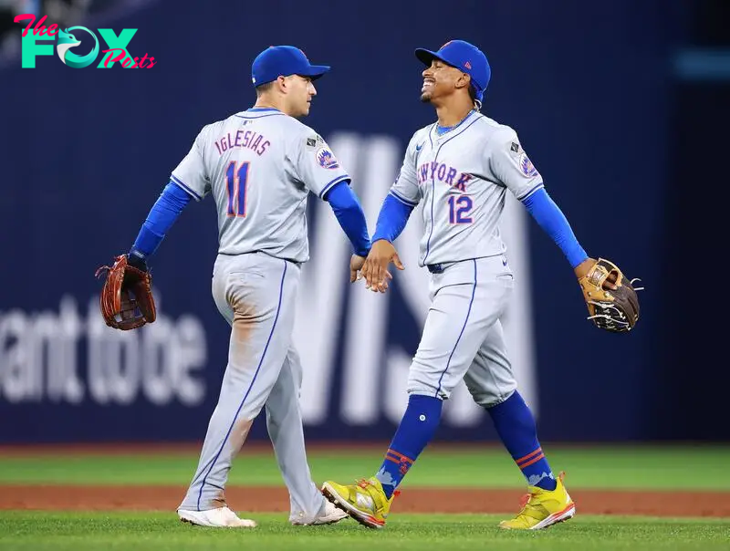 TORONTO, ON - SEPTEMBER 09: Francisco Lindor #12 and Jose Iglesias #11 of the New York Mets celebrate the win following a game against the Toronto Blue Jays at Rogers Centre on September 09, 2024 in Toronto, Ontario, Canada.   Vaughn Ridley/Getty Images/AFP (Photo by Vaughn Ridley / GETTY IMAGES NORTH AMERICA / Getty Images via AFP)