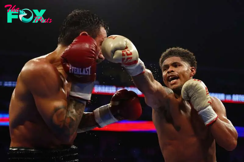 NEWARK, NEW JERSEY - JULY 06: Shakur Stevenson (gold gloves) trades punches with Artem Harutyunyan of Germany (red gloves) during their WBC Lightweight World Title fight at Prudential Center on July 06, 2024 in Newark, New Jersey.   Sarah Stier/Getty Images/AFP (Photo by Sarah Stier / GETTY IMAGES NORTH AMERICA / Getty Images via AFP)