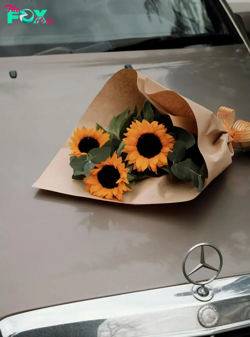 A bouquet of sunflowers on a car | Source: Pexels