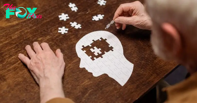 high angle view of senior man collecting jigsaw puzzle as dementia rehab