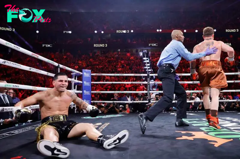 LAS VEGAS, NEVADA - SEPTEMBER 14: Edgar Berlanga sits on the canvas as referee Harvey Dock guides WBC/WBA/WBO super middleweight champion Canelo Alvarez to a neutral corner during the third round of a title fight at T-Mobile Arena on September 14, 2024 in Las Vegas, Nevada.   Steve Marcus/Getty Images/AFP (Photo by Steve Marcus / GETTY IMAGES NORTH AMERICA / Getty Images via AFP)