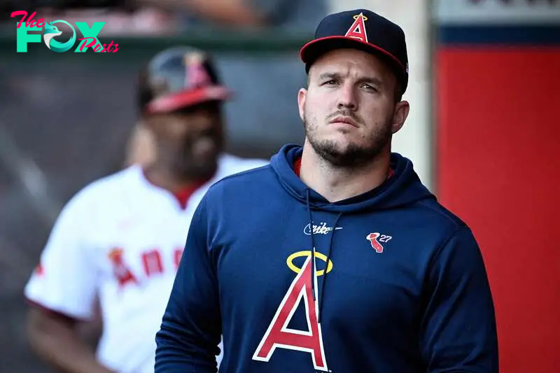 ANAHEIM, CALIFORNIA - AUGUST 01: Mike Trout #27 of the Los Angeles Angels looks on from the dugout during the first inning against the Colorado Rockies at Angel Stadium of Anaheim on August 01, 2024 in Anaheim, California.   Orlando Ramirez/Getty Images/AFP (Photo by Orlando Ramirez / GETTY IMAGES NORTH AMERICA / Getty Images via AFP)