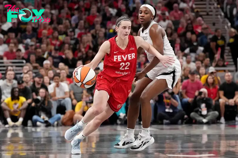 INDIANAPOLIS, INDIANA - SEPTEMBER 13: Caitlin Clark #22 of the Indiana Fever drives the ball against Jackie Young #0 of the Las Vegas Aces during the first half of a game at Gainbridge Fieldhouse on September 13, 2024 in Indianapolis, Indiana. NOTE TO USER: User expressly acknowledges and agrees that, by downloading and or using this photograph, User is consenting to the terms and conditions of the Getty Images License Agreement.   Emilee Chinn/Getty Images/AFP (Photo by Emilee Chinn / GETTY IMAGES NORTH AMERICA / Getty Images via AFP)