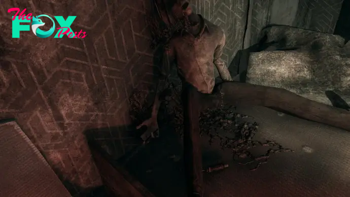 A screenshot from Hollowbody shows a body in the corner of a room. Its mouth is open, a strange, dark substance dripping from its face, painting the wall behind it and the floor between its legs