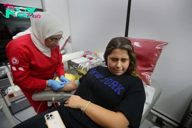 A Lebanese woman reacts as she donates blood for those who were injured at a Red Cross center in the southern port city of Sidon, Lebanon, on Sept. 17, 2024.