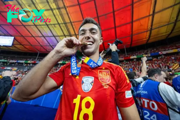 BERLIN, GERMANY - Sunday, July 14, 2024: Spain's Spain's Martín Zubimendi celebrates by biting his winners' medal after the UEFA Euro 2024 Final match between Spain and England at the Olympiastadion. Spain won 2-1. (Photo by David Rawcliffe/Propaganda)