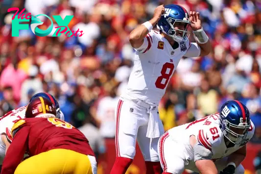 Sep 15, 2024; Landover, Maryland, USA; New York Giants quarterback Daniel Jones (8) signals at the line of scrimmage against the Washington Commanders at Commanders Field. Mandatory Credit: Peter Casey-Imagn Images