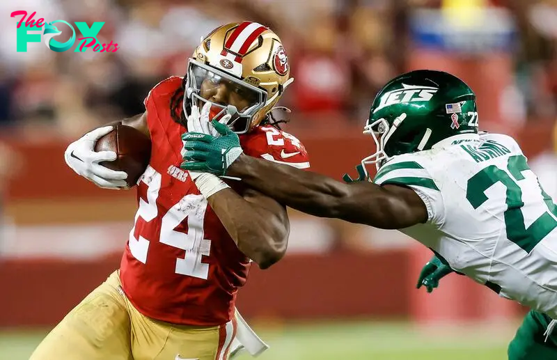 Running back Jordan Mason #24 of the San Francisco 49ers runs for a first down against safety Tony Adams #22 of the New York Jets