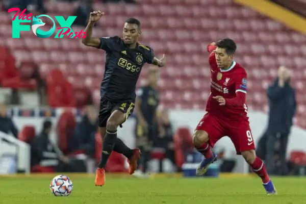 LIVERPOOL, ENGLAND - Tuesday, December 1, 2020: Ajax's Ryan Gravenberch (L) and Liverpool's Roberto Firmino during the UEFA Champions League Group D match between Liverpool FC and AFC Ajax at Anfield. Liverpool won 1-0 to win the group and progress to the Round of 16. (Pic by David Rawcliffe/Propaganda)