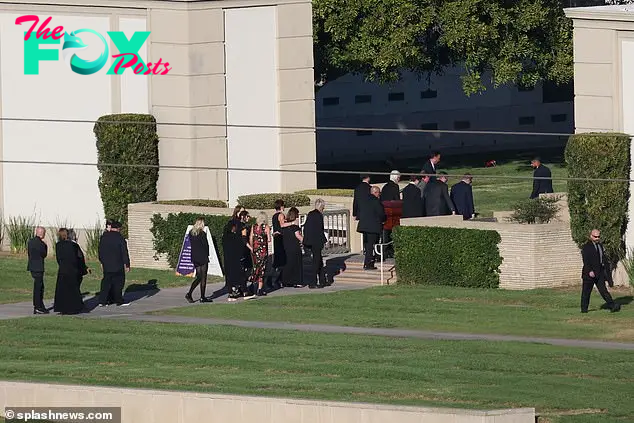 Perry's coffin is pictured being carried into church on Friday