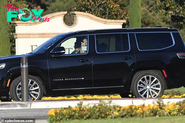 SUVs carrying mourners are seen on Friday outside the cemetery