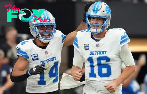 Detroit Lions receiver Amon-Ra St. Brown (14) and quarterback Jared Goff (16) celebrate after completing a hook and ladder play for a touchdown to teammate Jahmyr Gibbs (not pictured) during their game against the Arizona Cardinals at State Farm Stadium in Glendale, Ariz., Sep 22, 2024.