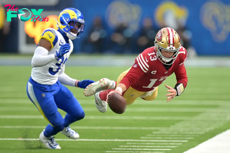 Sep 22, 2024; Inglewood, California, USA;  San Francisco 49ers quarterback Brock Purdy (13) gets past Los Angeles Rams linebacker Jacob Hummel (35) as he reaches mid-air for a first down before he is forced out of bounds in the second half at SoFi Stadium. Mandatory Credit: Jayne Kamin-Oncea-Imagn Images