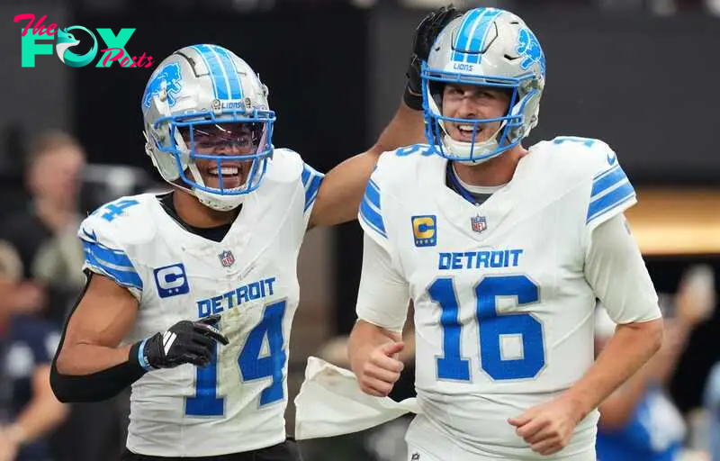 Detroit Lions receiver Amon-Ra St. Brown (14) and quarterback Jared Goff (16) celebrate after completing a hook and ladder play for a touchdown to teammate Jahmyr Gibbs (not pictured) during their game against the Arizona Cardinals at State Farm Stadium in Glendale, Ariz., Sep 22, 2024.