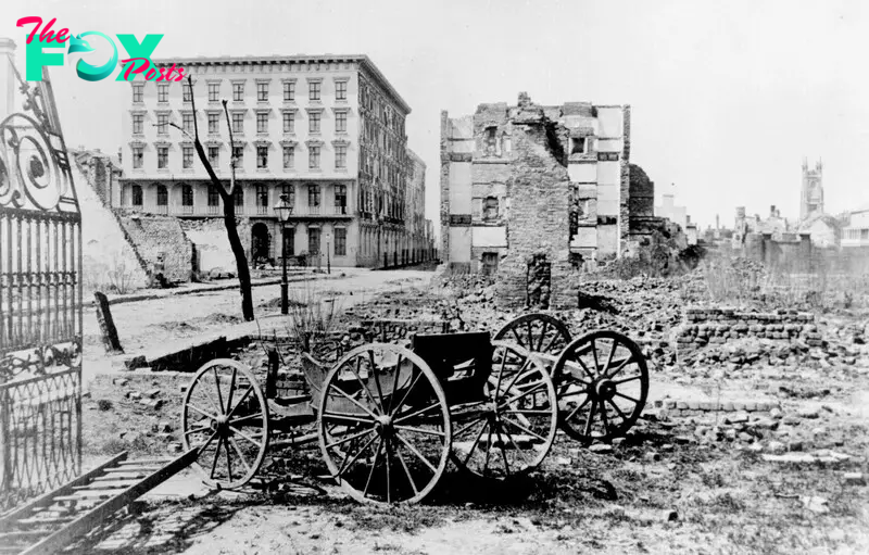 The ruins of Mills House and nearby buildings, Charleston, South Carolina, at end of American Civil War. A shell-damaged carriage and the remains of a brick chimney are in the foreground - 1865