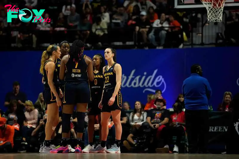 UNCASVILLE, CONNECTICUT - SEPTEMBER 22: Caitlin Clark #22 and the Indiana Fever await the whistle during the second half of a first round WNBA playoff game at Mohegan Sun Arena on September 22, 2024 in Uncasville, Connecticut. The Sun defeated the Fever 93-69. NOTE TO USER: User expressly acknowledges and agrees that, by downloading and or using this photograph, User is consenting to the terms and conditions of the Getty Images License Agreement.   Joe Buglewicz/Getty Images/AFP (Photo by Joe Buglewicz / GETTY IMAGES NORTH AMERICA / Getty Images via AFP)