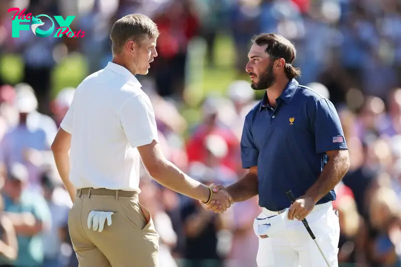 CHARLOTTE, NORTH CAROLINA - SEPTEMBER 24: Cam Davis of Australia and the International Team and Max Homa of the United States Team shake hands after Homa and Tony Finau of the United States Team won 4&3 over Davis and Si Woo Kim of South Korea and the International Team and during Saturday morning foursomes on day three of the 2022 Presidents Cup at Quail Hollow Country Club on September 24, 2022 in Charlotte, North Carolina.   Rob Carr/Getty Images/AFP