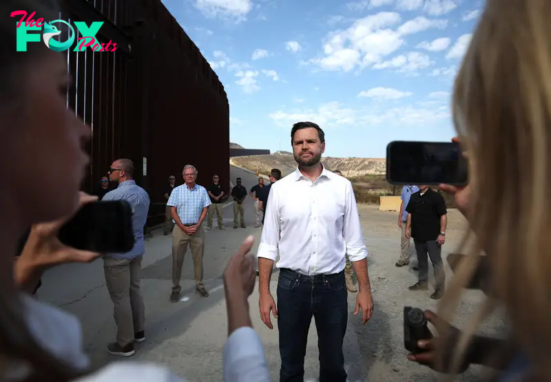 Vance speaks to reporters on Sept. 6 during a visit to the border wall near San Diego