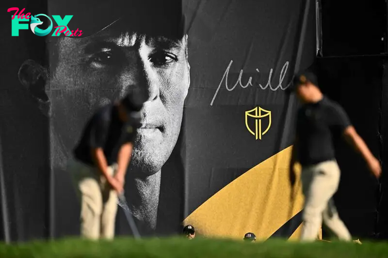 A International Team player putts in front of a banner of Captain Mike Weir during Thursday's Four-ball matches on day one of the 2024 Presidents Cup 