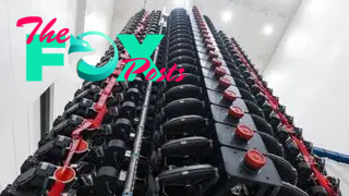 A large rack of satellites in a warehouse