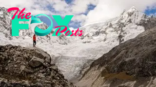 Woman looking to the peak of the Ranrapalca Glacier (6162 m) in Ancash Andes, Peru.