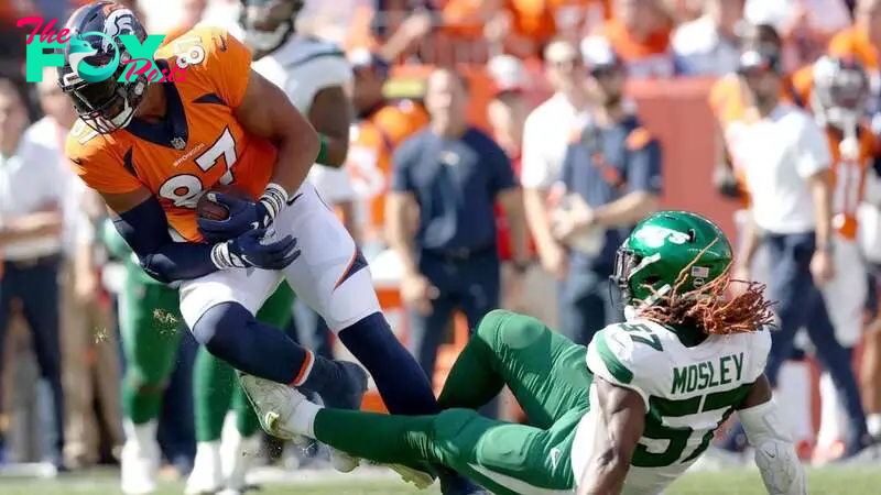 Noah Fant #87 of the Denver Broncos is tackled by C.J. Mosley #57 of the New York Jets at Empower Field At Mile High on September 26, 2021, in Denver, Colorado. 