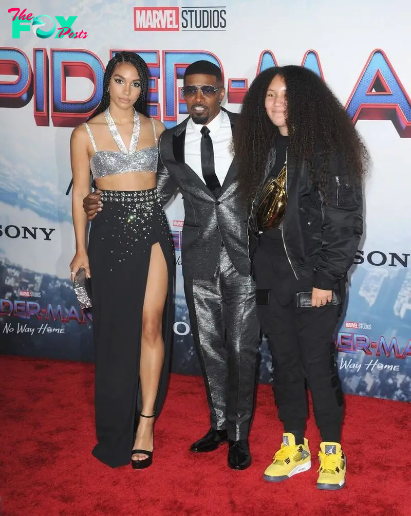 LOS ANGELES, CA - DECEMBER 13:   Corinne Foxx, Jamie Foxx and Annalise Foxx attend Sony Pictures' "Spider-Man: No Way Home" Los Angeles Premiere held at The Regency Village Theatre on December 13, 2021 in Los Angeles, California.  (Photo by Albert L. Ortega/Getty Images)