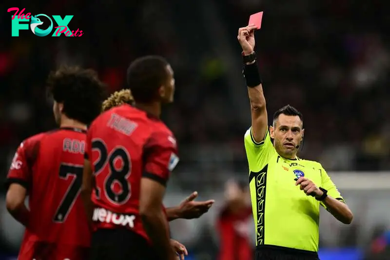 Referee Maurizio Mariani gives a red card to AC Milan's German defender #28 Malick Thiaw 