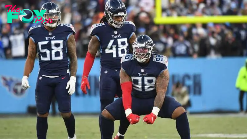 Jan 22, 2022; Nashville, Tennessee, USA; Tennessee Titans defensive end Jeffery Simmons (98) reacts after a play in front of outside linebacker Bud Dupree (48) and outside linebacker Harold Landry (58) during the first half of an AFC Divisional playoff fo