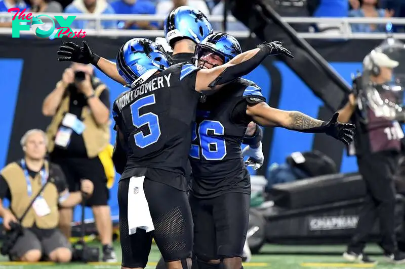 Sep 30, 2024; Detroit, Michigan, USA; Detroit Lions running back Jahmyr Gibbs (26) celebrates with teammate David Montgomery (5) after scoring a touchdown against the Seattle Seahawks in the second quarter at Ford Field. Mandatory Credit: Eamon Horwedel-Imagn Images