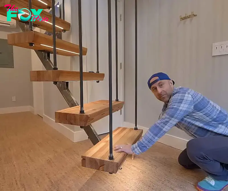 Nick, showing his eco-friendly home's unique staircase with lights under the steps.