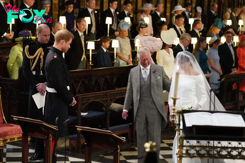 King Charles leads Meghan Markle down the aisle