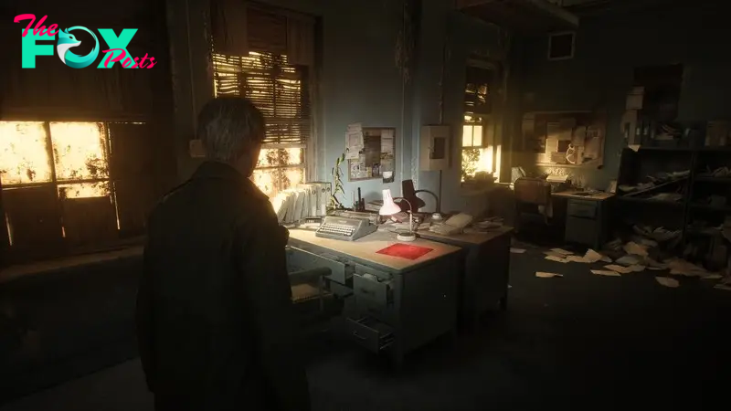 James, the protagonist of Silent Hill 2, faces away from the viewer and looks at a messy office with a desk in it, covered in papers and debris