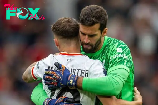 MANCHESTER, ENGLAND - Sunday, September 1, 2024: Liverpool's goalkeeper Alisson Becker (R) embraces Alexis Mac Allister during the FA Premier League match between Manchester United FC and Liverpool FC at Old Trafford. Liverpool won 3-0. (Photo by David Rawcliffe/Propaganda)