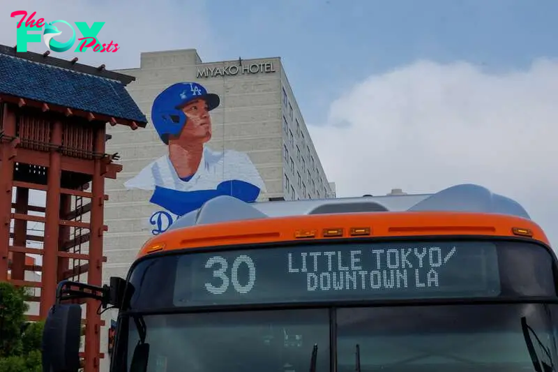 A giant mural of Shohei Ohtani, being painted by artist Robert Vargas on the side of a hotel in Little Tokyo, a neighborhood in downtown Los Angeles