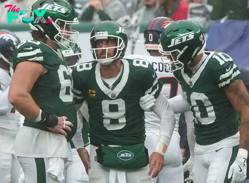 East Rutherford, NJ -- September 29 -- His team mates pick up Aaron Rodgers of the Jets after he was sacked in the fourth quarter as the Denver Broncos edged the New York Jets 10-9 at MetLife Stadium.