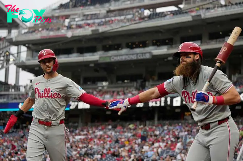 WASHINGTON, DC - SEPTEMBER 29: Trea Turner #7 high fives Brandon Marsh #16 of the Philadelphia Phillies after scoring on a ball hit by Alec Bohm #28 during the first inning against the Washington Nationals at Nationals Park on September 29, 2024 in Washington, DC.   Jess Rapfogel/Getty Images/AFP (Photo by Jess Rapfogel / GETTY IMAGES NORTH AMERICA / Getty Images via AFP)