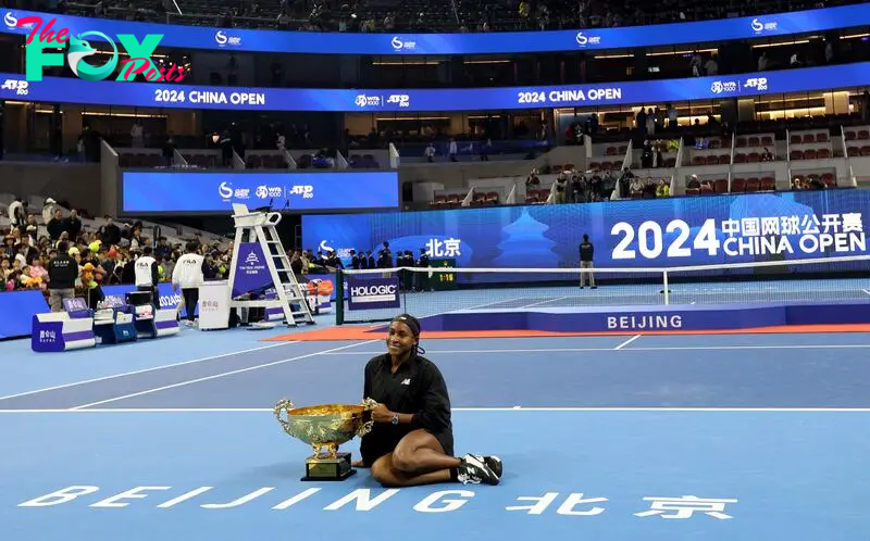 Tennis - China Open - China National Tennis Center, Beijing, China - October 6, 2024 Coco Gauff of the U.S. celebrates with the trophy after winning the China Open in the final against Czech Republic's Karolina Muchova REUTERS/Florence Lo