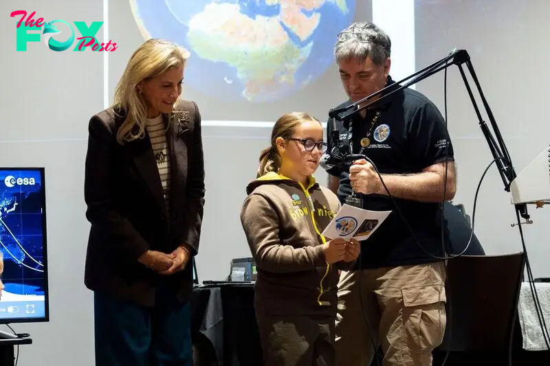 The Duchess of Edinburgh standing by young girl guide