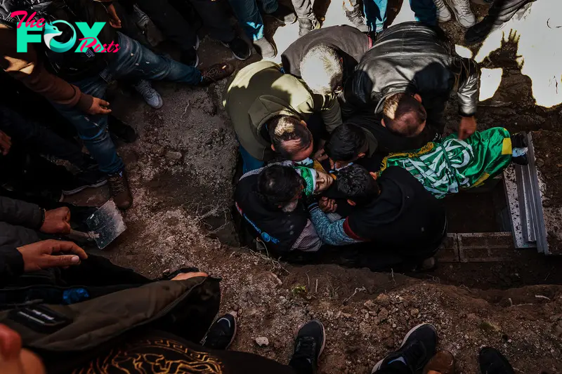 Family members bury Amro Najjar, 10, who was killed by Israeli forces during an incursion the day before, during a burial at the local cemetery in Burin, West Bank, March 5, 2024.