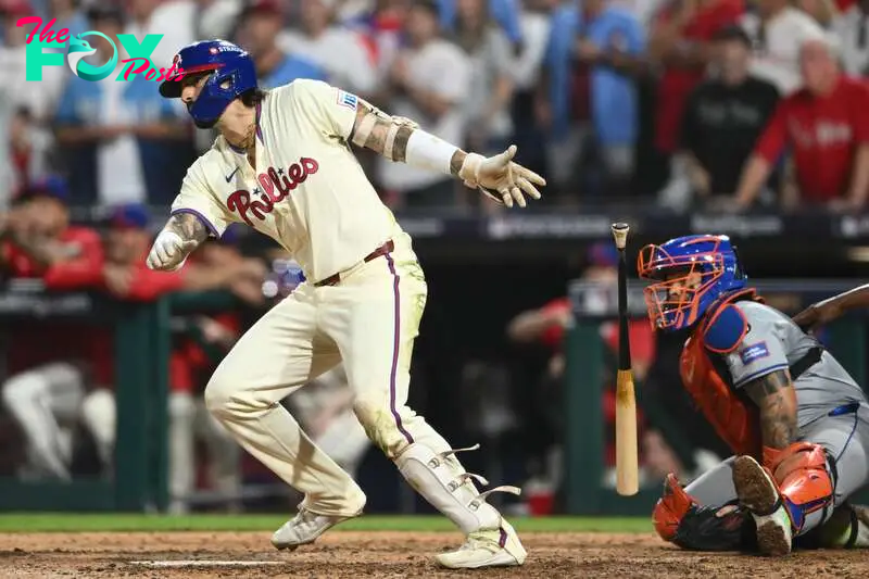 Oct 6, 2024; Philadelphia, Pennsylvania, USA; Philadelphia Phillies outfielder Nick Castellanos (8) hits a single in the ninth inning against the New York Mets during game two of the NLDS for the 2024 MLB Playoffs at Citizens Bank Park. Mandatory Credit: Kyle Ross-Imagn Images