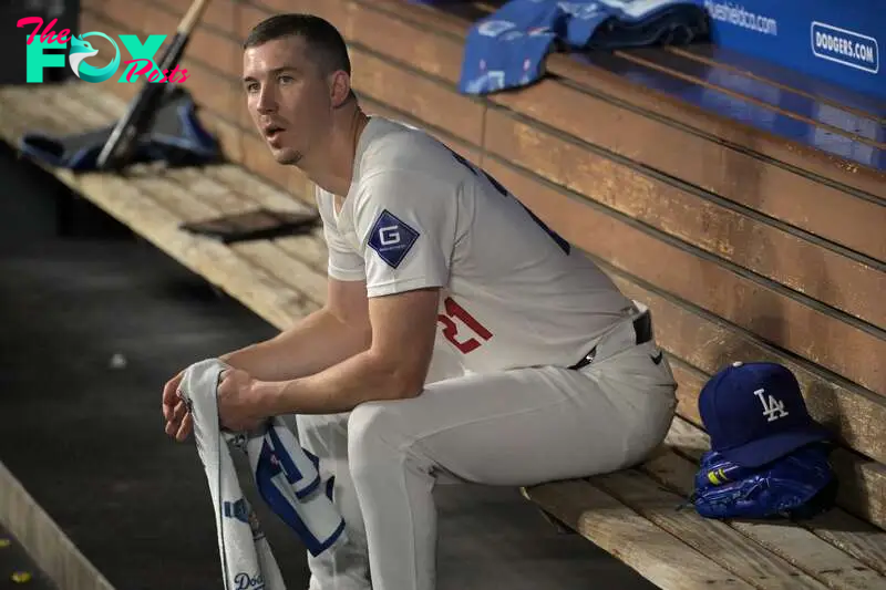 Sep 26, 2024; Los Angeles, California, USA;  Los Angeles Dodgers starting pitcher Walker Buehler (21) looks on from the dugout following the second inning against the San Diego Padres at Dodger Stadium. Mandatory Credit: Jayne Kamin-Oncea-Imagn Images