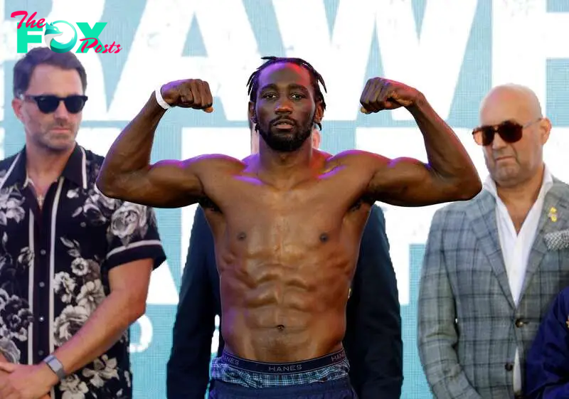 LOS ANGELES, CALIFORNIA - AUGUST 2: Terence Crawford (L), a welterweight undisputed champion, poses on the scale after his official weigh-in at LA Live on August 2, 2024 in Los Angeles, California. Crawford and Madrimov will fight for the super-welterweight title on Saturday August 3, 2024 at BMO Stadium in Los Angeles, California.   Kevork Djansezian/Getty Images/AFP (Photo by KEVORK DJANSEZIAN / GETTY IMAGES NORTH AMERICA / Getty Images via AFP)