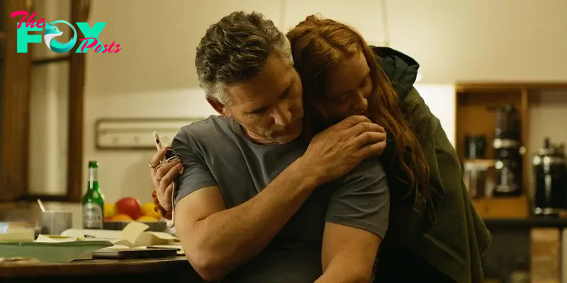 A man (Eric Bana) being consoled by a young girl (Sadie Sink) in A Sacrifice.